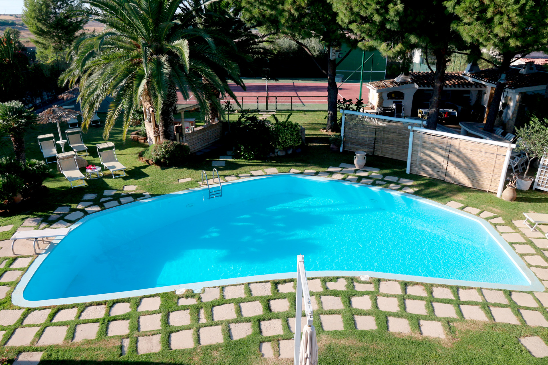 large swimming pool - tennis court and part of the garden